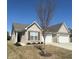 Charming single-story home with a brick facade, well-manicured lawn, and attached two-car garage on a sunny day at 6480 E Walton Dr, Camby, IN 46113