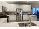 Open kitchen featuring white cabinetry, stainless steel appliances, and modern countertops for meal prep at 6480 E Walton Dr, Camby, IN 46113