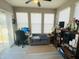 Bright, window-filled living room providing ample sunlight and featuring comfortable seating and home office setup at 6480 E Walton Dr, Camby, IN 46113