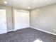 Empty bedroom with carpet, closet, and neutral walls bathed in natural light at 702 Eberhart Dr, Shelbyville, IN 46176