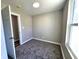 Neutrally decorated bedroom with carpet and natural light at 702 Eberhart Dr, Shelbyville, IN 46176