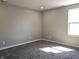 Empty bedroom with carpet, and neutral walls bathed in natural light at 702 Eberhart Dr, Shelbyville, IN 46176