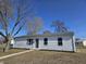 Charming one-story home with a well-manicured front lawn and mature trees at 702 Eberhart Dr, Shelbyville, IN 46176