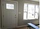 Bright entry featuring a decorative front door and a window with a view of the yard at 702 Eberhart Dr, Shelbyville, IN 46176