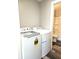 A well-lit laundry room with new washer and dryer set next to the bathroom at 702 Eberhart Dr, Shelbyville, IN 46176