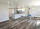 Open-concept living room and kitchen with hardwood floors at 702 Eberhart Dr, Shelbyville, IN 46176