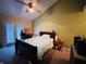 Cozy bedroom with a double bed, private patio access, neutral carpet, and fan lighting at 734 W 9Th St, Greenfield, IN 46140