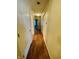 Hallway featuring wood floors, off-white walls, white doors, and lighting at 734 W 9Th St, Greenfield, IN 46140