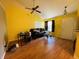 Bright living room with vaulted ceiling, dark leather sofa, hardwood floors, and natural light at 734 W 9Th St, Greenfield, IN 46140