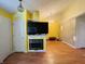 Empty living room showcasing a fireplace with mounted TV, and hardwood flooring, and adjacent spaces at 734 W 9Th St, Greenfield, IN 46140