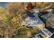 Aerial view of a home with a lakeside dock, sprawling lawn, and mature trees surrounding the residence at 7780 Paw Paw Dr, Nineveh, IN 46164