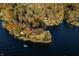 Aerial view of waterfront homes with private docks surrounded by beautiful lake and colorful fall foliage at 7780 Paw Paw Dr, Nineveh, IN 46164