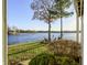 Inviting backyard with chairs, trees, and serene lake views, perfect for relaxation at 7780 Paw Paw Dr, Nineveh, IN 46164