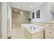 Bright bathroom features a large soaking tub, walk-in shower with glass surround, and vanity at 7780 Paw Paw Dr, Nineveh, IN 46164