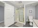 Bathroom featuring shower with glass door, gray tile flooring, and modern fixtures at 7780 Paw Paw Dr, Nineveh, IN 46164