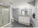 Updated bathroom features shower with glass door and vanity with drawers for storage at 7780 Paw Paw Dr, Nineveh, IN 46164