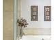 Close-up of soaking tub with decorative tile surround and leafy decorations at 7780 Paw Paw Dr, Nineveh, IN 46164