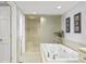 Bright bathroom with a large soaking tub, glass enclosed shower, and neutral tile at 7780 Paw Paw Dr, Nineveh, IN 46164