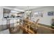 Dining room with hardwood floors, natural light, and connection to modern kitchen at 7780 Paw Paw Dr, Nineveh, IN 46164