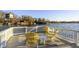 Relaxing lakeside deck area with yellow Adirondack chairs and scenic water view at 7780 Paw Paw Dr, Nineveh, IN 46164