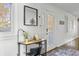 Bright entryway features a desk, decorative mirror, and a door leading to the outside at 7780 Paw Paw Dr, Nineveh, IN 46164