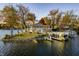 Picturesque lakefront property featuring a charming home with a spacious deck and private boat docks with slides at 7780 Paw Paw Dr, Nineveh, IN 46164