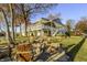 Large lakeside home with a fire pit and Adirondack chairs for outdoor relaxation at 7780 Paw Paw Dr, Nineveh, IN 46164