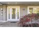 Inviting front entrance featuring a decorative door and manicured landscaping at 7780 Paw Paw Dr, Nineveh, IN 46164
