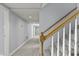 Well-lit hallway featuring neutral walls, plush gray carpet, and doors leading to various rooms at 7780 Paw Paw Dr, Nineveh, IN 46164