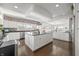Spacious kitchen featuring hardwood floors, large island, stainless appliances, and white cabinetry at 7780 Paw Paw Dr, Nineveh, IN 46164