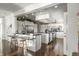 Open-concept kitchen features dark countertops, an island with seating, and stainless steel appliances at 7780 Paw Paw Dr, Nineveh, IN 46164