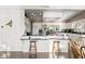 Bright kitchen with white cabinets, breakfast bar, modern appliances, and hardwood floors at 7780 Paw Paw Dr, Nineveh, IN 46164
