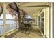 Enjoy lake views from the spacious covered patio with outdoor dining area, perfect for entertaining or relaxing outdoors at 7780 Paw Paw Dr, Nineveh, IN 46164