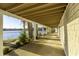 Covered porch with lake view, cedar shake siding, and views of the lake at 7780 Paw Paw Dr, Nineveh, IN 46164