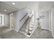 Bright and airy staircase with gray carpet, white risers, and wooden handrail leading to upper level at 7780 Paw Paw Dr, Nineveh, IN 46164