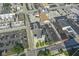 Aerial view of property and neighborhood showcasing the building and a nearby church on a sunny day at 802 N Meridian St # 204, Indianapolis, IN 46204