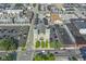 Aerial view of property and neighborhood showcasing the building and a nearby church on a sunny day at 802 N Meridian St # 204, Indianapolis, IN 46204