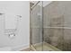 Updated bathroom features a glass-enclosed shower with neutral tiling and modern fixtures at 802 N Meridian St # 204, Indianapolis, IN 46204