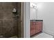 Bathroom featuring a walk-in shower and a double vanity with granite countertop at 802 N Meridian St # 204, Indianapolis, IN 46204