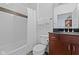 Bathroom with a shower and tub combination, dark wood cabinets and elegant mosaic tiling at 802 N Meridian St # 204, Indianapolis, IN 46204