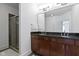 Bathroom featuring a double vanity with granite countertop and a walk-in shower at 802 N Meridian St # 204, Indianapolis, IN 46204