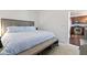 Bright bedroom with a comfortable bed, and view into the updated kitchen at 802 N Meridian St # 204, Indianapolis, IN 46204