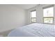 Bright bedroom with two large windows offering city views and a bed with light blue sheets at 802 N Meridian St # 204, Indianapolis, IN 46204