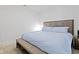 Cozy bedroom showcasing a large bed with an upholstered headboard and bench at the foot at 802 N Meridian St # 204, Indianapolis, IN 46204