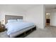 Bedroom featuring a queen bed with blue bedding and a bench at the foot of the bed at 802 N Meridian St # 204, Indianapolis, IN 46204