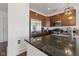 Kitchen featuring stainless steel appliances, dark wood cabinets, and granite countertops at 802 N Meridian St # 204, Indianapolis, IN 46204