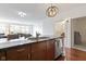 Kitchen featuring stainless steel appliances, dark wood cabinets, granite countertops and an eat-in area at 802 N Meridian St # 204, Indianapolis, IN 46204
