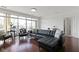 Modern living area with hardwood floors, a leather sofa, and floor-to-ceiling windows that let in tons of light at 802 N Meridian St # 204, Indianapolis, IN 46204