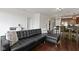 Open-concept living room with a black leather sofa and desk next to the dining and kitchen areas at 802 N Meridian St # 204, Indianapolis, IN 46204