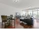 Spacious living area features hardwood floors, a black leather sofa, and lots of natural light at 802 N Meridian St # 204, Indianapolis, IN 46204